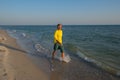 Happy traveler is walking along the surf line Royalty Free Stock Photo