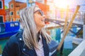 Happy traveler woman having fun near colorful houses on Burano island in Venetian lagoon. Travel and vacation in Italy Royalty Free Stock Photo