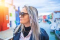 Happy traveler woman having fun near colorful houses on Burano island in Venetian lagoon. Travel and vacation in Italy Royalty Free Stock Photo