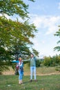 Happy travelers couple conquered top of mountain, raises hands up Royalty Free Stock Photo