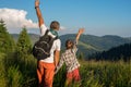 Happy travelers: a man and a boy are standing amidst lush grass Royalty Free Stock Photo