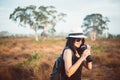 Happy traveller asian woman drinking water from the bottle in spending time at forest,Lifestyle travel outdoor concept