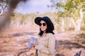 Happy traveller asian woman drinking water from the bottle in spending time at forest,Lifestyle travel outdoor concept Royalty Free Stock Photo