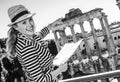 Happy traveller woman near Roman Forum holding map and pointing Royalty Free Stock Photo