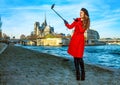 Happy traveller woman in Paris taking selfie using selfie stick Royalty Free Stock Photo