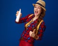 Happy traveller woman showing thumbs up showing bottle of spray