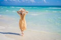 Happy traveller woman in yellow dress enjoys her tropical beach vacation. GO Everywhere Royalty Free Stock Photo