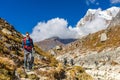 Happy trekker girl hiking in the mountains of Nepal Royalty Free Stock Photo