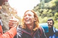 Happy trekkers helping each others hiking on mountaing path - Real people faces having fun on trekking day - Survival, helping, Royalty Free Stock Photo