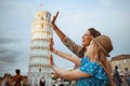 Happy trendy family posing at Leaning Tower in Pisa, Italy