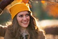 happy trendy female in beige coat and orange hat