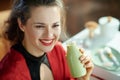 Happy trendy female with bottle of yoghurt