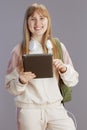 happy trendy girl in beige tracksuit with backpack Royalty Free Stock Photo