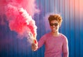 Happy trendy guy with bomb of colored smoke Royalty Free Stock Photo