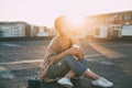 Hipster millennial cute woman on rooftop at sunset