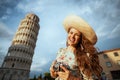 Happy trendy solo traveller woman in floral dress