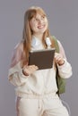 happy trendy teenage girl in beige tracksuit with backpack Royalty Free Stock Photo
