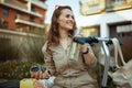 Happy trendy woman in overall outdoors in city Royalty Free Stock Photo