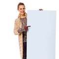 Happy trendy woman on white pointing at blank board Royalty Free Stock Photo