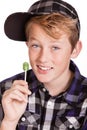 Happy trendy young boy holding a lollipop Royalty Free Stock Photo