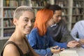 Happy trendy young student girl studying in university library Royalty Free Stock Photo