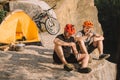 happy trial bikers eating canned food in camping Royalty Free Stock Photo