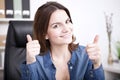 Happy triumphant businesswoman giving a thumbs up Royalty Free Stock Photo