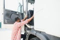 Happy truck driver entering in vehicle cabin. Royalty Free Stock Photo