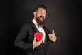 happy tuxedo man pointing finger on heart. happy valentines day. be my valentine. Royalty Free Stock Photo