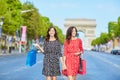 Happy twin sisters doing shopping on holidays in France Royalty Free Stock Photo