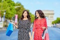 Happy twin sisters doing shopping on holidays in France Royalty Free Stock Photo