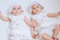 Happy twin sisters playing at home on a white background Royalty Free Stock Photo