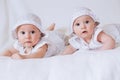 Happy twins in funny hats. Children girls 7 months