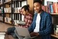 Happy two african men students using laptop computer. Royalty Free Stock Photo