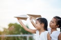 Happy two asian child girls playing with toy paper airplane Royalty Free Stock Photo