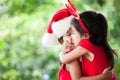 Happy two asian child girls in santa dress hugging each other Royalty Free Stock Photo