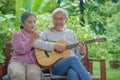 senior couple elderly man playing the guitar while his wife is singing together Royalty Free Stock Photo