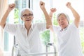 Happy two asian senior women raising fist and hurrah,time together,friends of elderly woman or sister smiling,laughing and raising Royalty Free Stock Photo