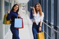 Happy two caucasian women are doing shopping together at the mall center. Two young women are walking with shopping bags at mall Royalty Free Stock Photo