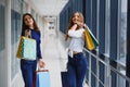 Happy two caucasian women are doing shopping together at the mall center. Two young women are walking with shopping bags at mall Royalty Free Stock Photo