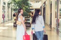 Two girl-friends are walking with bags at the shopping centre. Royalty Free Stock Photo
