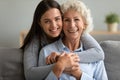 Happy two generation women hugging looking at camera, family portrait Royalty Free Stock Photo