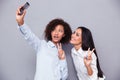 Happy two girls making selfie photo on smartphone Royalty Free Stock Photo