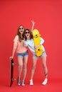 Happy two ladies friends holding skateboards. Royalty Free Stock Photo