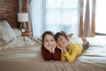 Happy two little girls lying on the bed Royalty Free Stock Photo