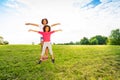 Happy two little girls sisters wave hands at park Royalty Free Stock Photo