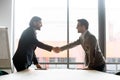 Happy two male business partners shaking hands, starting negotiations meeting. Royalty Free Stock Photo