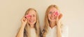 Happy two women, mother and adult daughter covering her eyes with pink rose flower buds Royalty Free Stock Photo