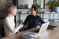 Happy two young mixed race business women shaking hands. Royalty Free Stock Photo