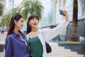 Happy two young women taking selfie on city street Royalty Free Stock Photo